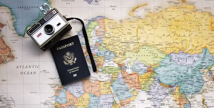Passport and camera on a world map